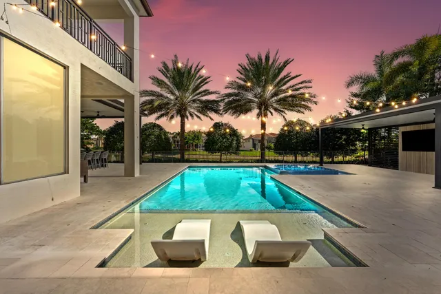 a view of swimming pool with a lounge chair