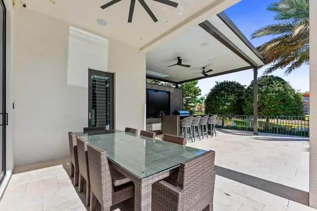 a dining room with furniture and a floor to ceiling window