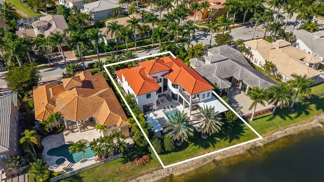 an aerial view of a house with a garden and swimming pool