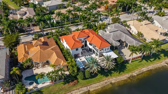 an aerial view of residential houses with outdoor space and swimming pool