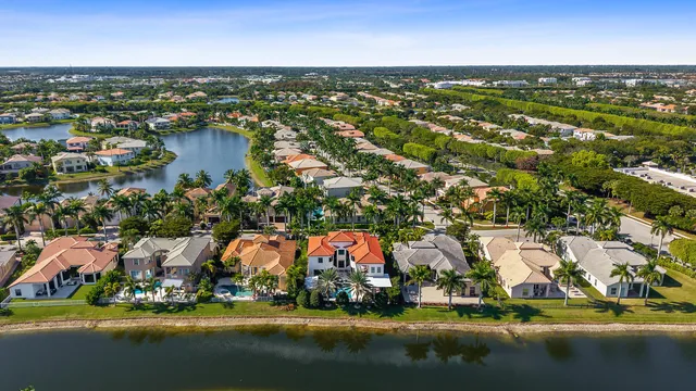 an aerial view of residential houses with outdoor space and swimming pool