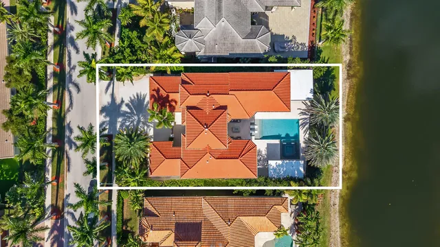 an aerial view of a house with a yard and trees