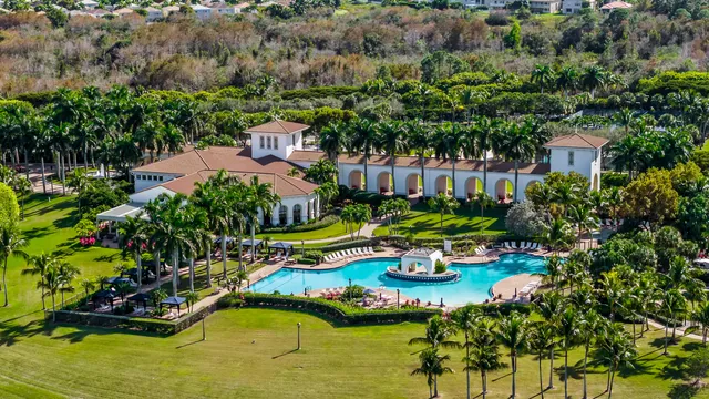 an aerial view of residential houses with outdoor space and lake view