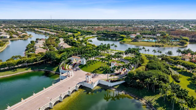an aerial view of residential houses with outdoor space and lake view