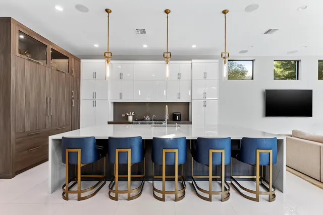 a large kitchen with a table and chairs