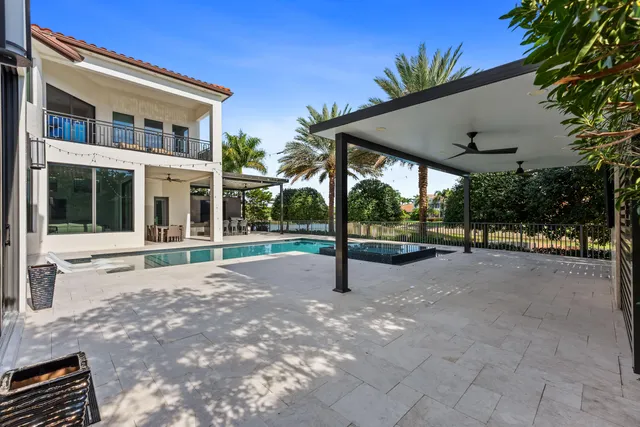a view of a house with backyard and tree s