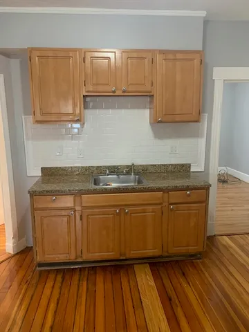 a kitchen with granite countertop wooden cabinets and a granite counter tops