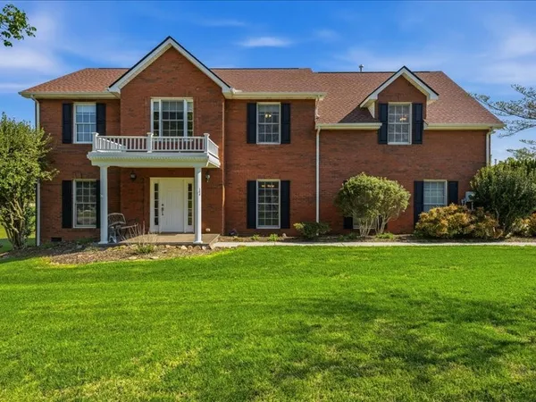 a front view of a house with a garden and yard