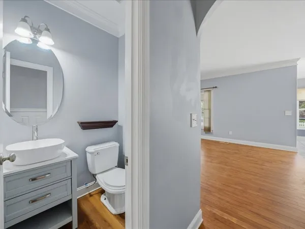 a bathroom with a toilet a sink and mirror