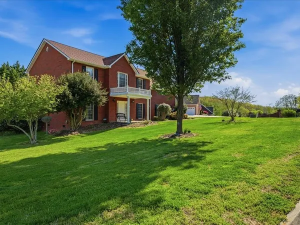 a front view of house with yard and green space