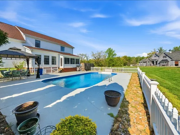 a view of swimming pool with outdoor seating and plants