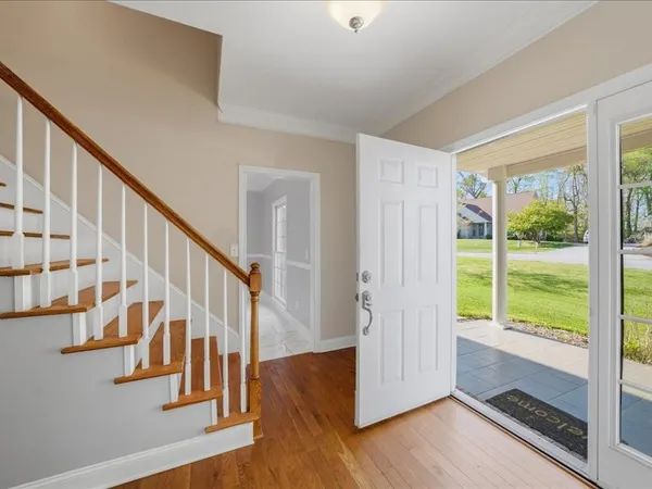 a view of entryway with wooden floor and windows