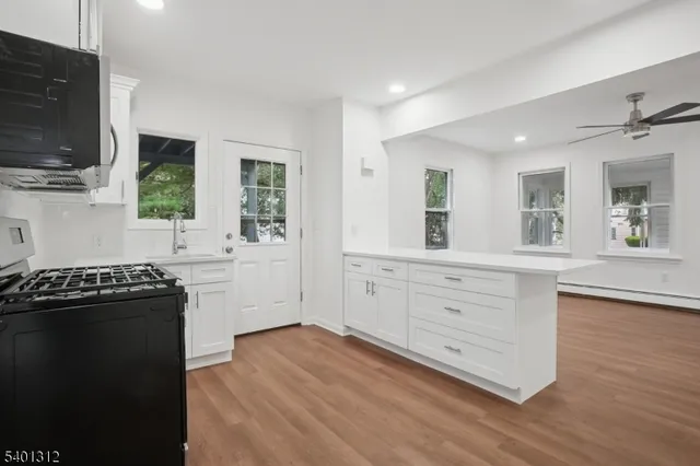a kitchen with stainless steel appliances a refrigerator and a stove top oven