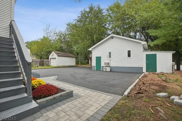 a view of a white house with a yard and garage
