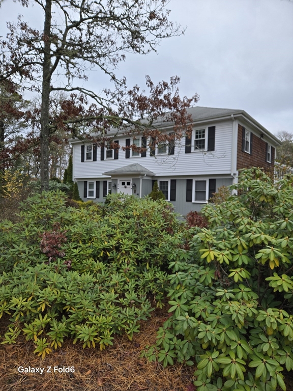 a view of a house with a garden and balcony