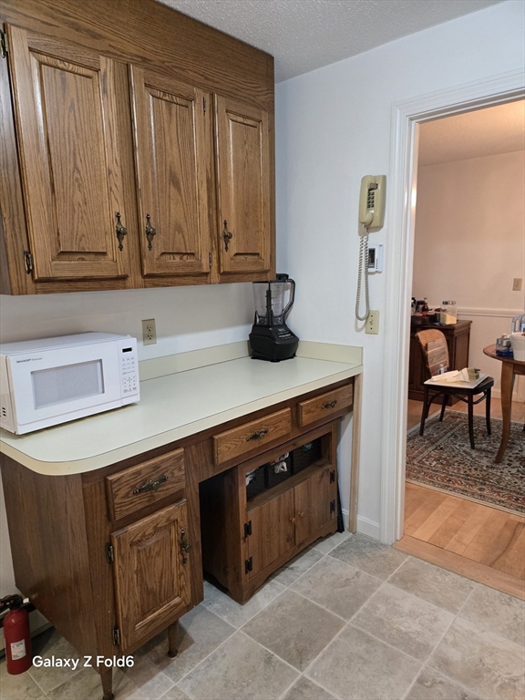 222 Buck Island Road, Unit 45 Yarmouth, MA 02673 - Photo 13 of 26 a kitchen with stainless steel appliances granite countertop a stove a sink and a microwave