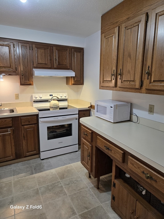 222 Buck Island Road, Unit 45 Yarmouth, MA 02673 - Photo 14 of 26 a kitchen with a stove and a sink