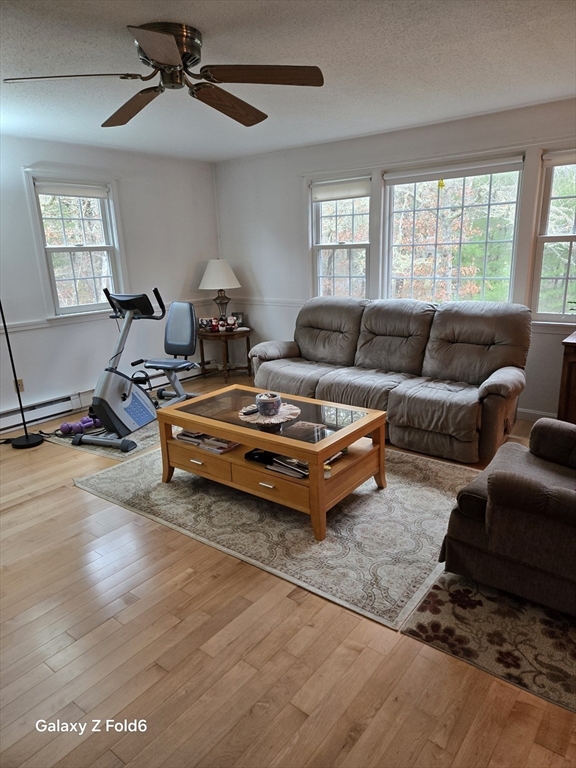 222 Buck Island Road, Unit 45 Yarmouth, MA 02673 - Photo 5 of 26 a living room with furniture gym equipment and a window