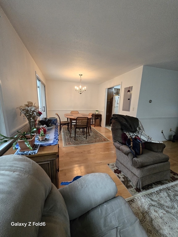222 Buck Island Road, Unit 45 Yarmouth, MA 02673 - Photo 6 of 26 a living room with furniture a rug and a dining table
