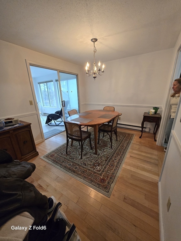 222 Buck Island Road, Unit 45 Yarmouth, MA 02673 - Photo 7 of 26 a view of a dining room with furniture and wooden floor