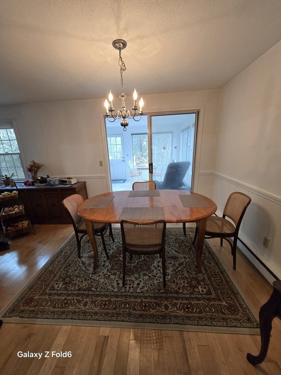 222 Buck Island Road, Unit 45 Yarmouth, MA 02673 - Photo 8 of 26 a view of a dining room with furniture and wooden floor
