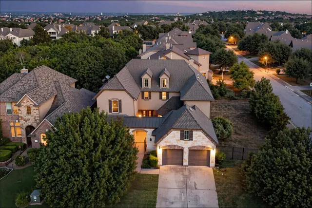 an aerial view of a house with a yard