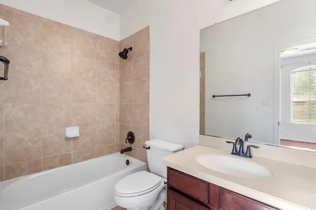 a bathroom with a sink a toilet and bathtub