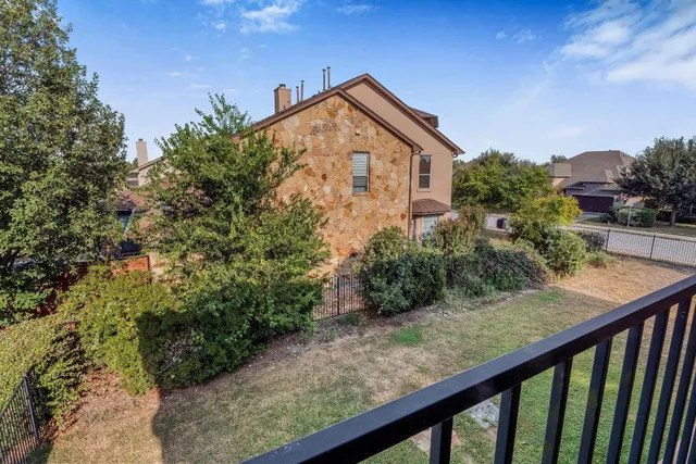 a view of a wooden fence next to a yard