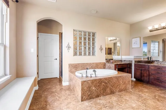 a spacious bedroom with a large bed and a dresser