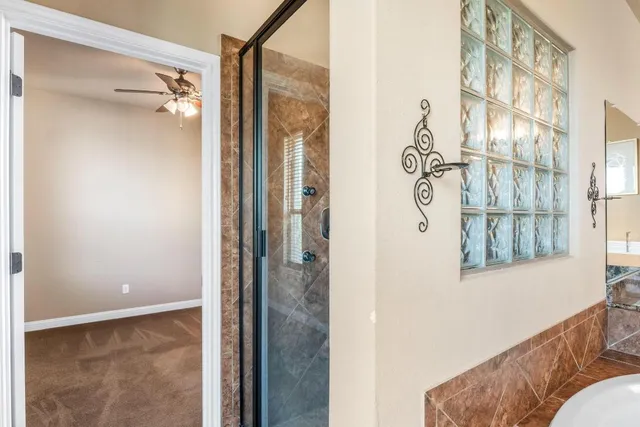 a view of a bathroom with a glass door and shower