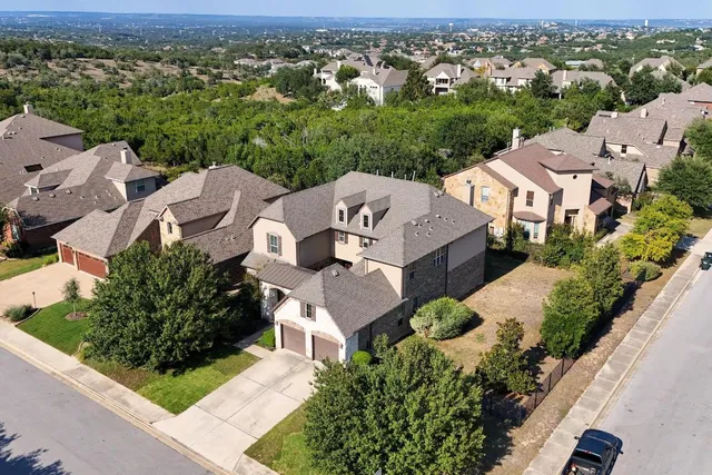 an aerial view of multiple houses with a yard