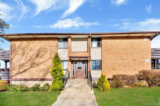 a front view of a house with a garden and pathway