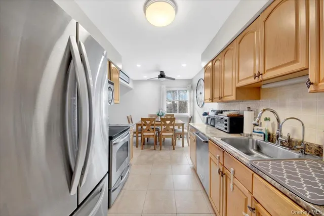 a kitchen with stainless steel appliances granite countertop a refrigerator and a sink