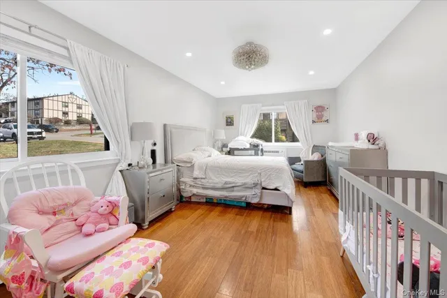 a bedroom with furniture and a large window