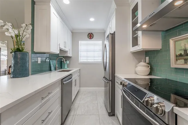 a kitchen with granite countertop a sink stove and cabinets