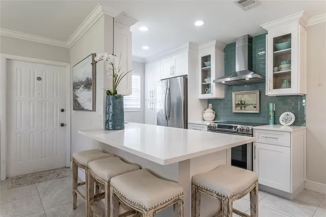 a large kitchen with a table and chairs