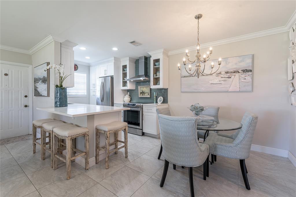 1130 Cir Terrace West, Unit D Delray Beach, FL 33445 - Photo 13 of 39 a view of a dining room with furniture and chandelier