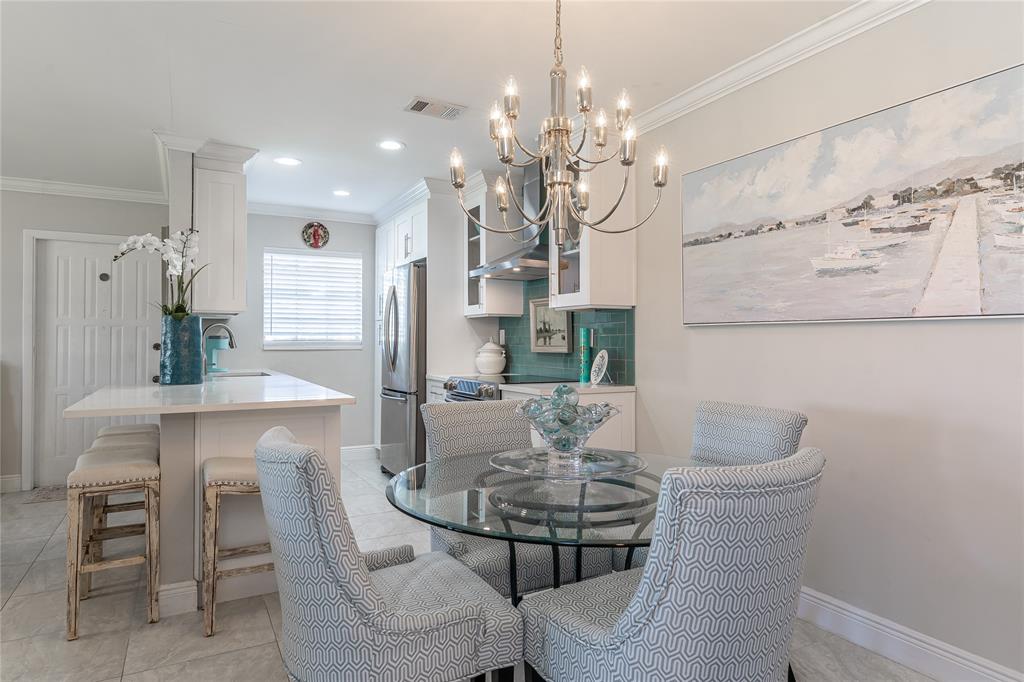 1130 Cir Terrace West, Unit D Delray Beach, FL 33445 - Photo 14 of 39 a view of a dining room with furniture and chandelier