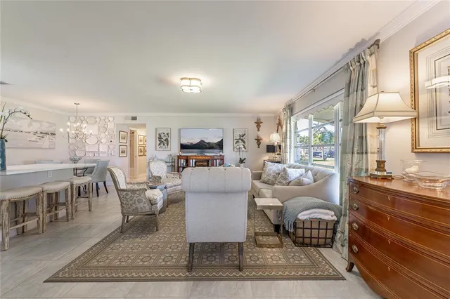 a living room with furniture a rug and a table