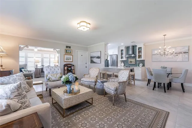 a living room with furniture and a dining table