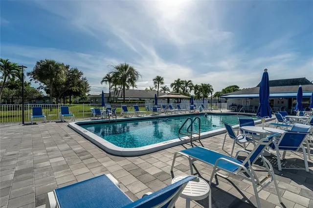 a view of a swimming pool with chairs