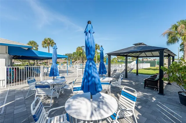 a dining room with furniture a chandelier and wooden floor