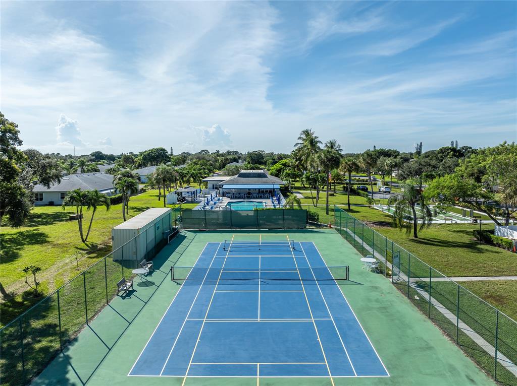 1130 Cir Terrace West, Unit D Delray Beach, FL 33445 - Photo 33 of 39 a view of a swimming pool and a chairs