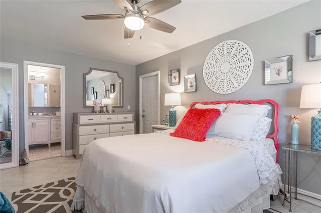 a bedroom with a large bed and a chandelier
