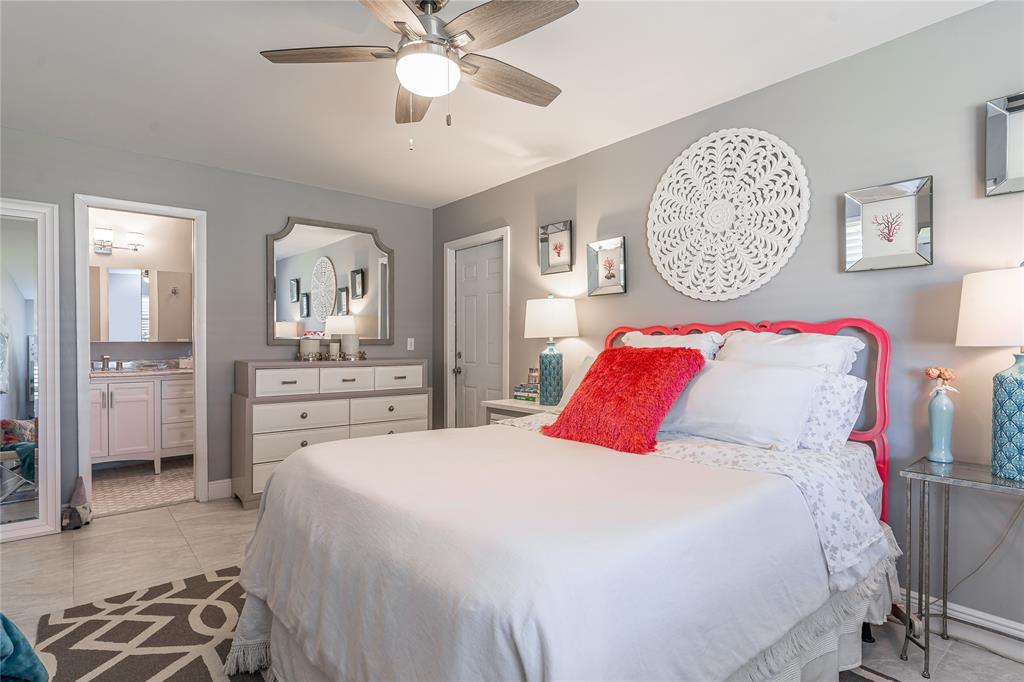 1130 Cir Terrace West, Unit D Delray Beach, FL 33445 - Photo 6 of 39 a bedroom with a large bed and a chandelier