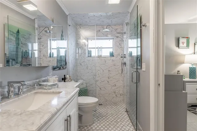 a bathroom with a granite countertop sink toilet and shower