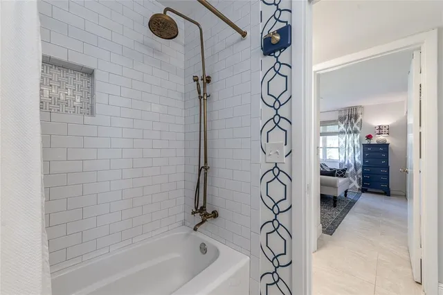 a bathroom with a granite countertop sink a mirror and a shower