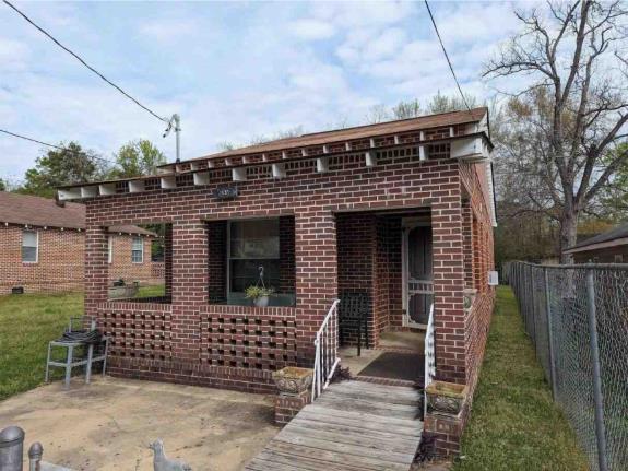 a front view of a house with a fence