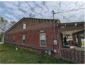 2835 Thomas Street Columbus, GA 31906 - Photo 4 of 19 a brick building with a bench in front of it