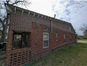2835 Thomas Street Columbus, GA 31906 - Photo 6 of 19 a brick building with a small yard